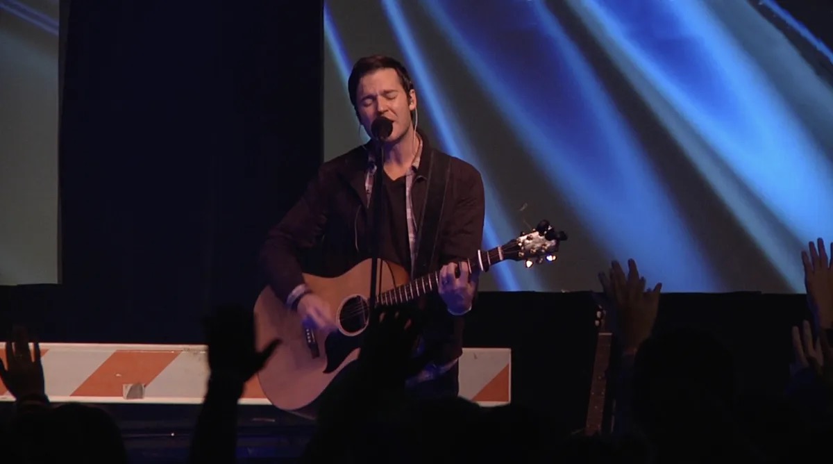 Nathan Peterson performing with guitar